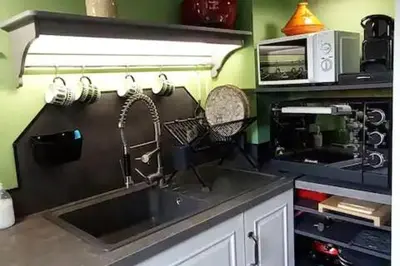 a kitchen with a sink and a microwave at Logement lumineux, entièrement rénové avec jardin in Caumont-sur-Durance