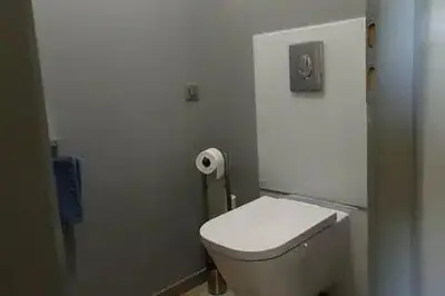 a bathroom with a toilet and a roll of toilet paper at Logement lumineux, entièrement rénové avec jardin in Caumont-sur-Durance