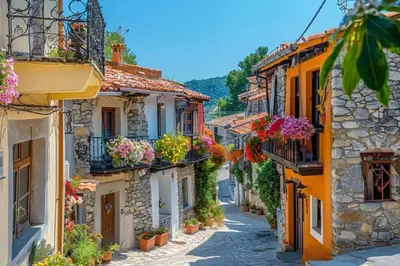 an alley in an old town with flowers in buckets at Logement lumineux, entièrement rénové avec jardin in Caumont-sur-Durance