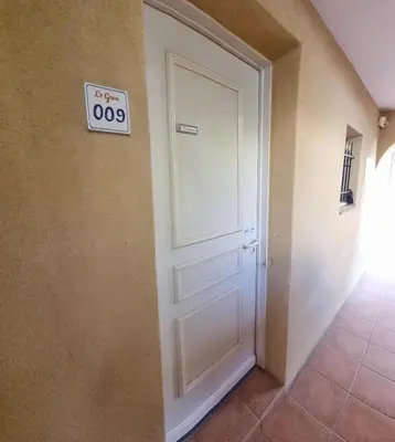 a door in a room with a sign on it at Hôtel du Golf de Pont Royal - appartement paisible rez de jardin - terrasse & piscine in Mallemort