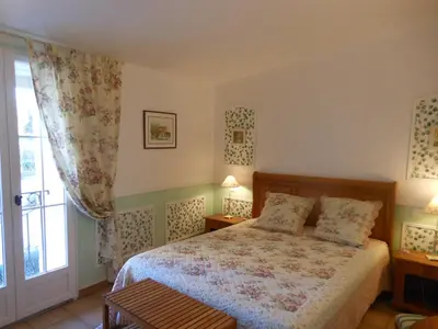 a bedroom with a bed and a window at Les Passiflores in Roussillon