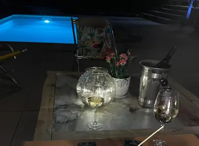a glass of wine sitting on a table with two wine glasses at Proche Saint Rémy de Provence in Mollégès
