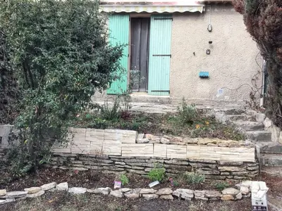 a house with a green door and stairs in front at Maison de charme à Vachères avec jardin et vue montagne in Vachères
