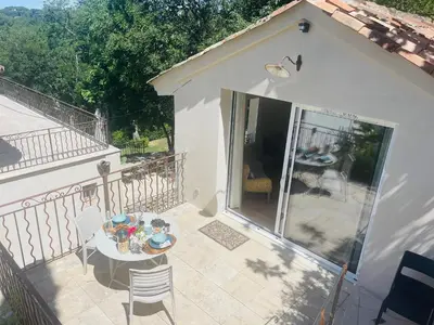 a patio with a table and chairs on a balcony at Appart13 piscine chauffée de luxe Belvoir13 à 10 min d Aix in Aix-en-Provence