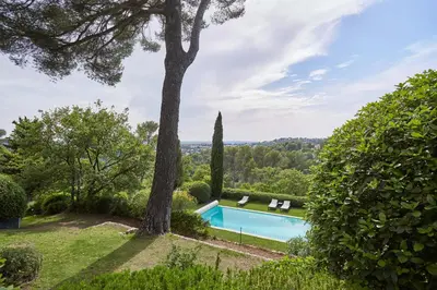 a swimming pool in a yard with a tree at Appart13 piscine chauffée de luxe Belvoir13 à 10 min d Aix in Aix-en-Provence