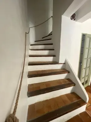 a staircase in a house with a rope going up it at Le Petit Egregore, patio et climatisation in Lauris