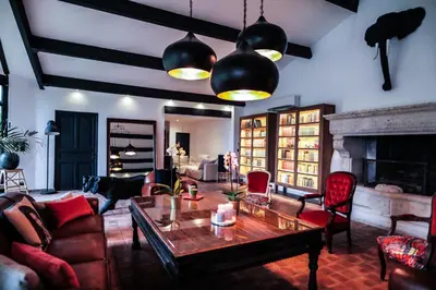 a living room with a table and a fireplace at L'Insoupçonnée Saint Rémy de Provence by A Pinch Of Soul in Noves