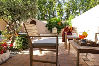a patio with two chairs and a table at L'Insoupçonnée Saint Rémy de Provence by A Pinch Of Soul in Noves