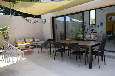 a patio with a table and chairs and a couch at superb villa with private pool, with magnificent view of the luberon, in the heart of provence, 8 persons in Puget