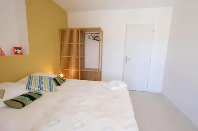 a bedroom with a large white bed with two pillows at superb villa with private pool, with magnificent view of the luberon, in the heart of provence, 8 persons in Puget