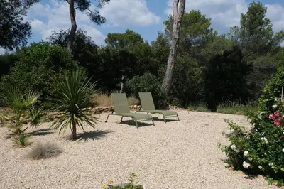 two green chairs sitting in the middle of a garden at superb villa with private pool, with magnificent view of the luberon, in the heart of provence, 8 persons in Puget