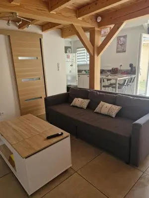 a living room with a couch and a table at Petite maison meublée entre Avignon et Carpentras in Morières-lès-Avignon