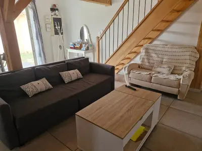 a living room with a couch and a chair at Petite maison meublée entre Avignon et Carpentras in Morières-lès-Avignon