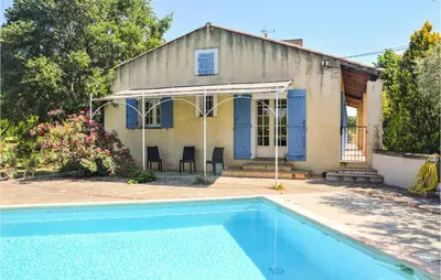 a house with a swimming pool in front of a house at Nice Home In Lançon-Provence in Lançon-Provence