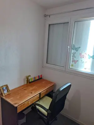 a desk in a room with a chair and a window at Plein centre ville Appartement in Salon-de-Provence