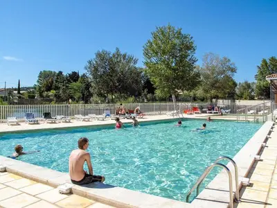 a group of people in a swimming pool at Casa De Provence in Saint-Saturnin-les-Avignon