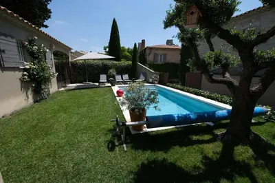 a swimming pool in the yard of a house at charmante location vacances avec piscine dans les alpilles, à aureille, proche du centre du village à pied- magnifique vue - 6 couchages. in Aureille