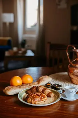 a plate of croissants and oranges on a table at Provence Now in Cabrières-dʼAvignon