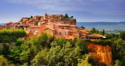 a village on top of a mountain with trees at Provence Now in Cabrières-dʼAvignon