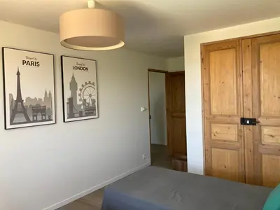 a room with a bed and two pictures on the wall at La bastide in Malemort-du-Comtat