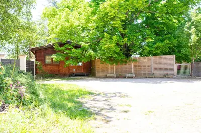 a building with a fence and a tree at Gîte sous le Tilleul, Luberon in Croagnes