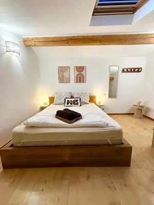 a bedroom with a large bed in a room at Maisonnette avec terrasse privée au calme absolu - proche LOURMARIN in Cadenet