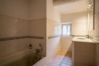 a bathroom with a tub and a sink at Propriété d'exception au coeur du Luberon in Robion en Luberon