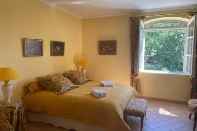 a bedroom with a bed with two towels on it at Propriété d'exception au coeur du Luberon in Robion en Luberon