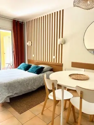 a bedroom with a bed and a table and chairs at Village Pont Royal en Provence - maeva Home - Studio 4 personnes - Sélection MAE-2934 in Mallemort