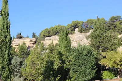 a view of a mountain with trees and rocks at Gîte Les Rapières in Gordes