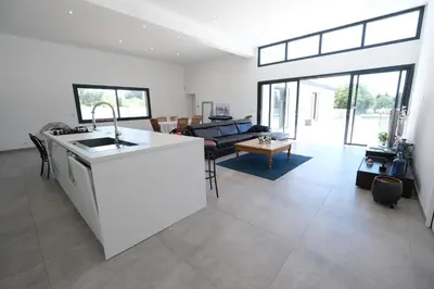 a kitchen and living room with a counter top at LS6-408 ERNO Villa contemporaine avec piscine privée 8 couchages à Chateauneuf de Gadagne - Proche d’Avignon in Châteauneuf-de-Gadagne