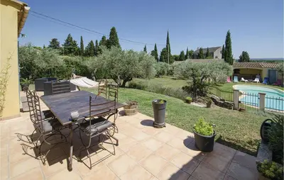 a patio with a table and chairs and a pool at Amazing Home In Caumont Sur Durance in Caumont-sur-Durance