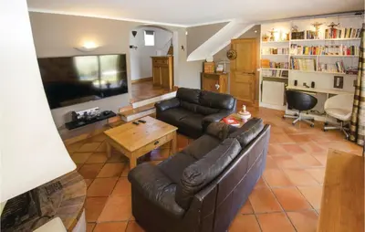 a living room with a couch and a table at Amazing Home In Caumont Sur Durance in Caumont-sur-Durance
