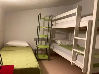 a room with two bunk beds and a ladder at Les demeures du Ventoux in Aubignan