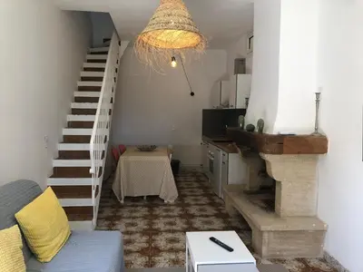 a living room with a staircase and a couch at La Tour- Pigeonnier Provençal - Mas des Sous Bois in Ventabren