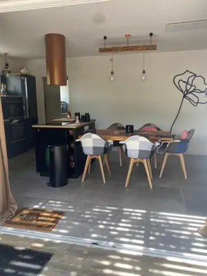 a kitchen with a table and chairs in a room at Gite Couleur Terre à 10MN de Gordes in Croagnes