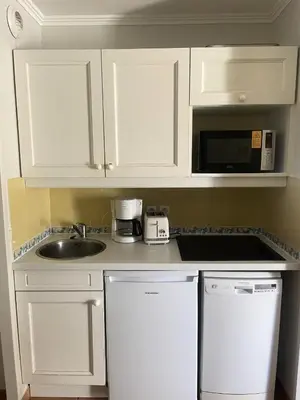 a kitchen with white cabinets and a sink and a microwave at Village Pont Royal en Provence - maeva Home - Appartement 2 Pièces 5 Personnes Sélection MAE-2164 in Mallemort
