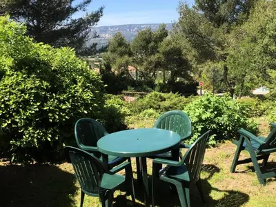 a table and chairs with a blue table and chairs at Village Pont Royal en Provence - maeva Home - Appartement 2 Pièces 5 Personnes Sélection MAE-2164 in Mallemort