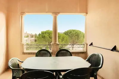a table and chairs in a room with a window at Village Pont Royal en Provence - maeva Home - Appartement 2 Pièces 7 Personnes Confort MAE-2253 in Mallemort