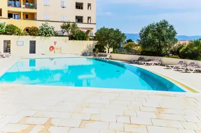 a swimming pool with chairs and a building at Les Coteaux de Pont Royal en Provence - maeva Home - Appartement 2 Pièces 4 Personnes - Confort MAE-5993 in Mallemort