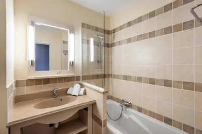 a bathroom with a sink and a tub and a mirror at Les Coteaux de Pont Royal en Provence - maeva Home - Appartement 2 Pièces 4 Personnes - Confort MAE-5993 in Mallemort