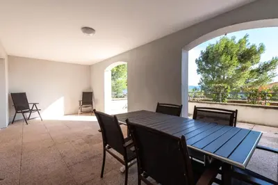 a dining room with a table and chairs and a large window at Les Coteaux de Pont Royal en Provence - maeva Home - Appartement 3 Pièces 6 Personnes - Sélection MAE-6001 in Mallemort