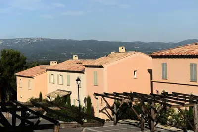 a group of buildings with a view of a town at Les Coteaux de Pont Royal en Provence - maeva Home - Appartement 2 Pièces 4 Personnes - Confort MAE-6002 in Mallemort