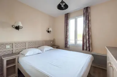 a bedroom with a white bed and a window at Les Coteaux de Pont Royal en Provence - maeva Home - Maison 4 Pièces 8 Personnes - Budget MAE-6009 in Mallemort