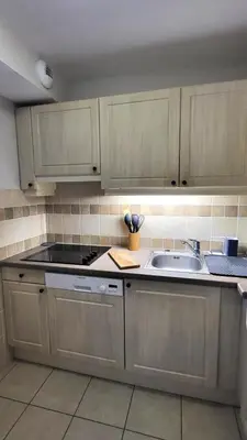 a kitchen with wooden cabinets and a sink at Les Coteaux de Pont Royal en Provence - maeva Home - Maison 4 Pièces 8 Personnes - Sélection MAE-6014 in Mallemort
