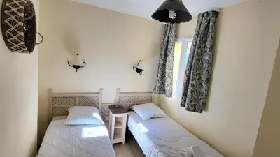 a room with two beds and a window at Les Coteaux de Pont Royal en Provence - maeva Home - Maison 4 Pièces 8 Personnes - Sélection MAE-6014 in Mallemort