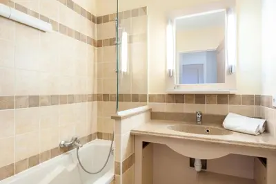 a bathroom with a sink and a mirror and a tub at Les Coteaux de Pont Royal en Provence - maeva Home - Appartement 2 Pièces 4 Personnes - Sélection MAE-6016 in Mallemort