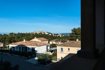 a view of a town with a building on a hill at Les Coteaux de Pont Royal en Provence - maeva Home - Appartement climatisé 2 Pièces 4 Personnes - Sélection MAE-6022 in Mallemort