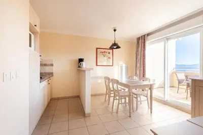 a kitchen and dining room with a table and chairs at Les Coteaux de Pont Royal en Provence - maeva Home - Appartement climatisé 2 Pièces 4 Personnes - Sélection MAE-6022 in Mallemort