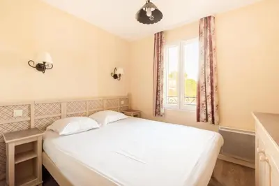 a bedroom with a white bed and a window at Les Coteaux de Pont Royal en Provence - maeva Home - Maison 4 Pièces 8 Personnes - Sélection MAE-6026 in Mallemort